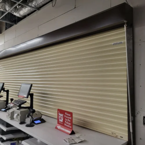 commercial beige garage door of a grey house